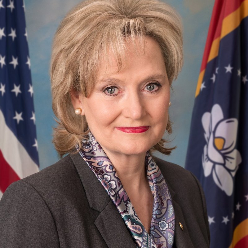 Official US Senate headshot of Cindy Hyde-Smith in front of the US and Mississippi flags, 2021